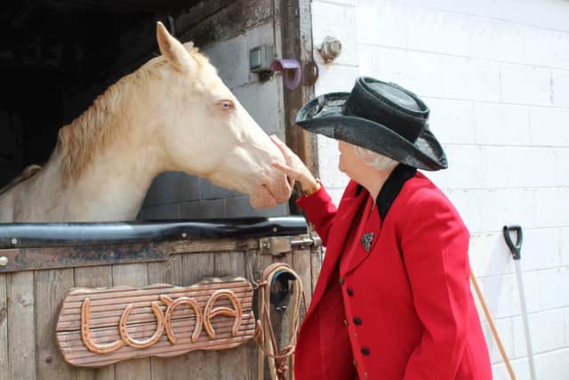 'Queen Lizzie' exploring the grounds and petting the ponies in the stables.