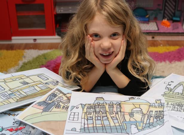 Chloe Daykin aged eight with some of her detailed pictures of some of Mansfield's landmarks. The little girl with autism and ADHD has developed her own unique style.