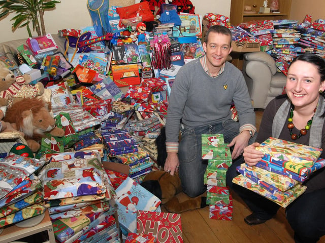 Hetty's team leader Emma-Jane Knight and kinship care lead Craig Knowles with their collection of Christmas presents collected in the community. 2010.