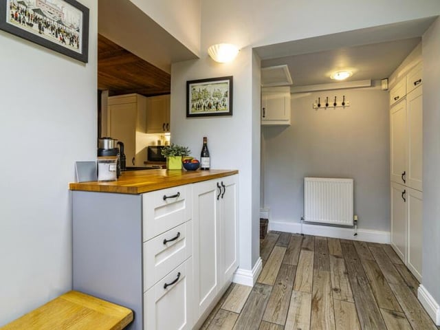 Next to the kitchen is a useful utility room, providing extra storage and functionality.