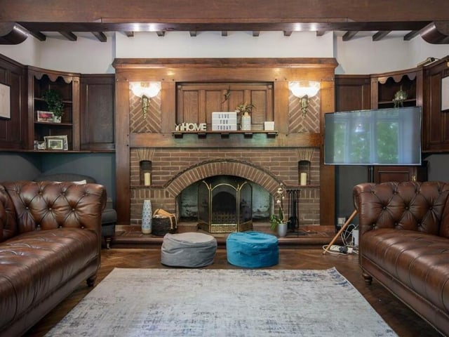 The living room is of an exceptional standard, complete with original parquet flooring, coving to the ceiling and a striking feature fireplace that adds warmth to an elegant space.