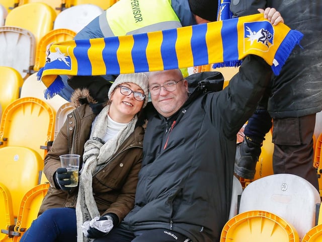 Mansfield Town fans watch the match against Northampton Town.