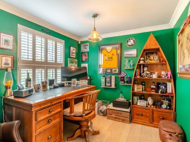 This busy home office or study has a lot going for it, including a double-glazed window with fitted shutters. Coving to the ceiling, a laminate floor and an aluminium radiator add to its appeal.