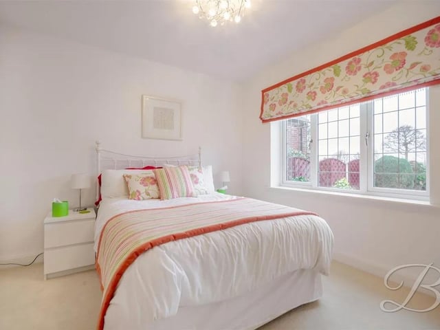 The third bedroom offers ample space, carpeted flooring and a wardrobe along with a window to the rear elevation.