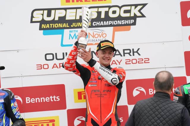 Winner Max Cook on the podium at Oulton Park.