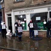 Activists Ann Donlan (far left), Jerry Hague (centre left), Claire Broomhead (middle), Alan Spencer (centre right) and Mick Coakley (far right) protested outside the Conservative MP's office.