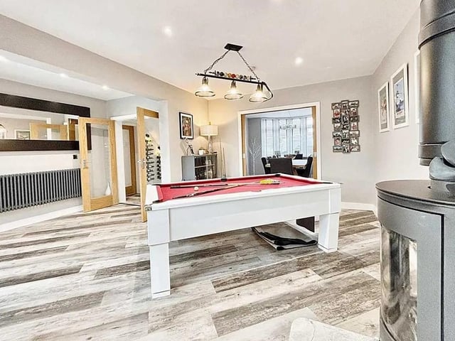 The lounge is open plan to the kitchen and boasts a cosy log burner, lvt flooring throughout, huge sliding doors leading out to the patios and garden - perfect for hosting parties.