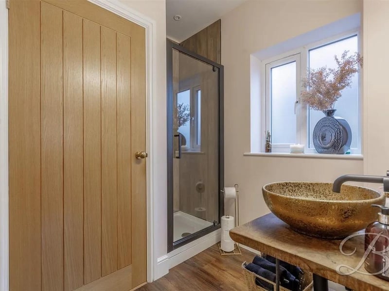 The en-Suite is complete with a walk-in shower cubicle, low flush WC, hand wash basin, and an opaque window to the side elevation.