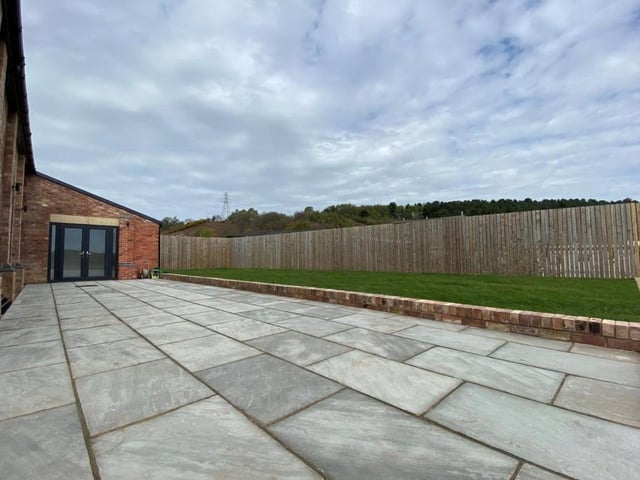 The exterior of the Old Pumping Station is extensive and could be put to any kind of use. This paved area could be turned into a pleasant patio for entertaining family and friends.