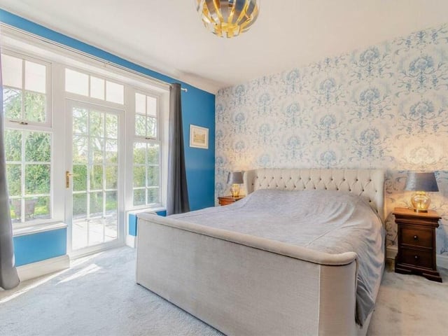 The first bedroom to look at, a large double, is a bright and bonny space, thanks mainly to two large windows and a patio door leading out to the back garden.