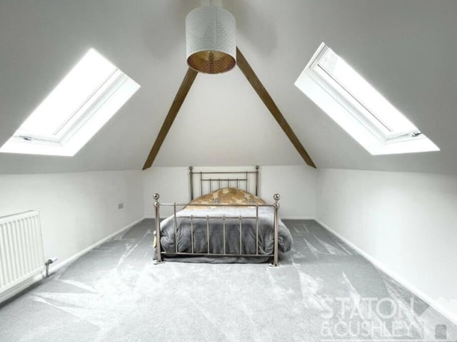 The first of the double bedrooms on the first floor is big and bright, thanks to double-glazed skylight windows facing both sides. It has access to an en suite shower room.