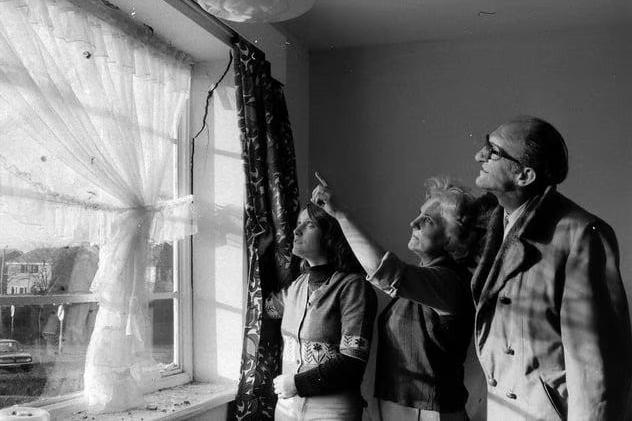 Observing the damage to the windowsill caused from the storm in 1976,