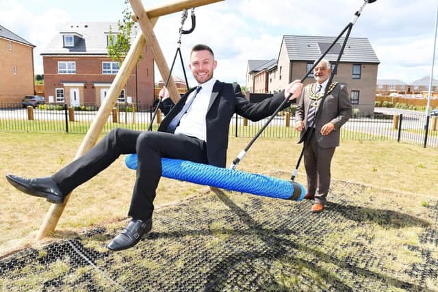 Cllr Grafton and Josh Malone giving the play equipment a test run in Sutton-in-Ashfield