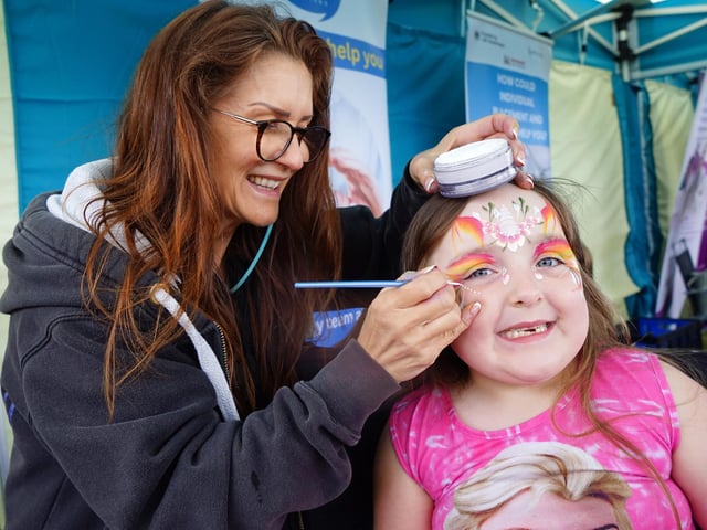 Harper-Jean Ball is having her face painted by Lorraine Hopewell from Butterfly Effex Ltd.