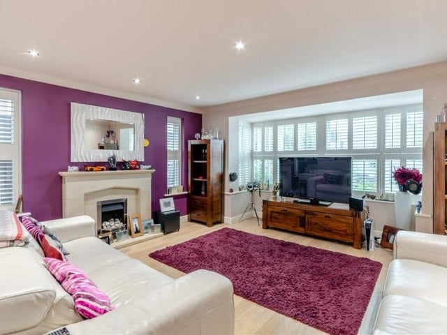 The main reception room on the ground floor of the £500,000 house is this spacious and stylish lounge. It is distinguished by a stone fireplace with inset gas fire, but is also notable for its laminate floor by Quick-Step, large, double-glazed bay window facing the back of the house and eight LED ceiling spotlights.