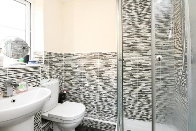 This en suite shower room belongs to the master bedroom. As well as a shower cubicle, it features a low-flush WC and wash hand basin,