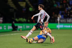 Louis Reed makes a fine tackle at Bolton. Photo credit Chris & Jeanette Holloway / The Bigger Picture.media
