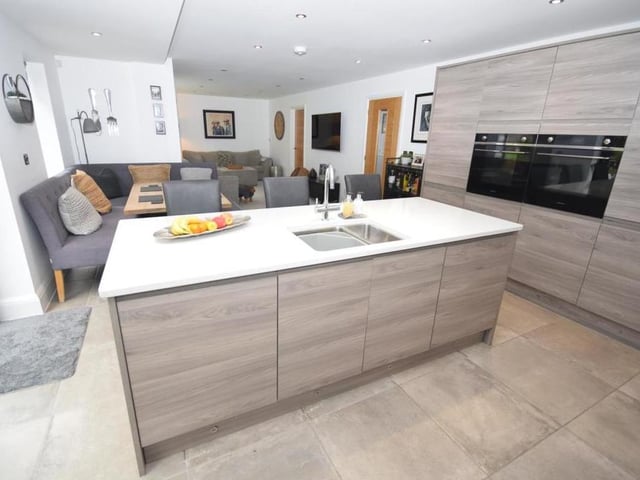 High-quality fixtures in the dining kitchen include two ovens, a four-ring halogen hob with extractor above, fridge, freezer and dishwasher. The wine cooler ensures you are always ready to entertain.