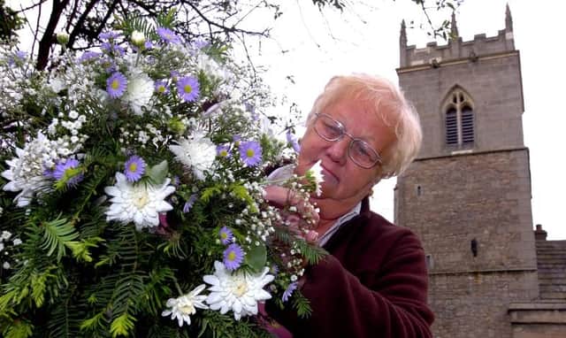 Loversall church turned 800 years old in 2006. Here is Leila Payne with her flower arrangement.