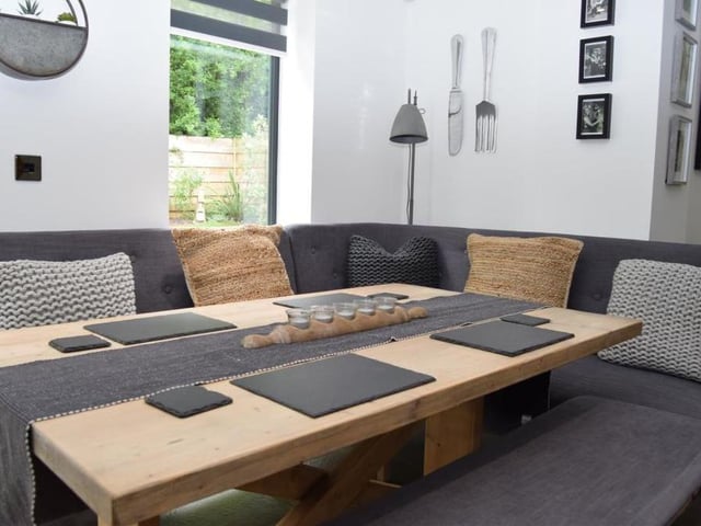 The open-plan dining kitchen also includes a lovely dining area, which has ample room for table and chairs. A window overlooks the garden.