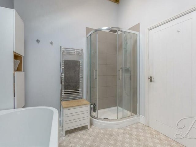 As well as a free-standing bath, the bathroom offers the option of a shower cubicle.