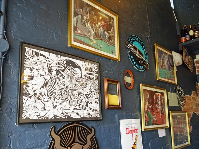 The walls are adorned with pub-themed pictures and advertisements.