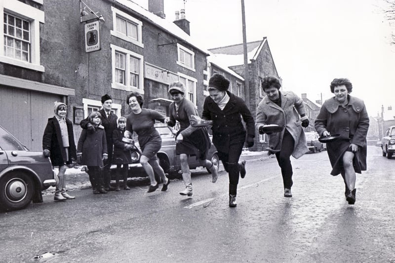The ladies race for the tape during one of the pancake races along the village street in Winster, Nr Matlock February 1969