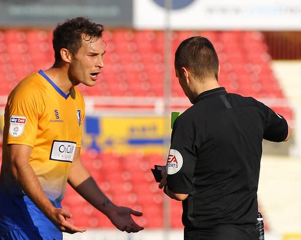 Mansfield Town's Will Atkinson is about to be sent off at Swindon Town in 2018.