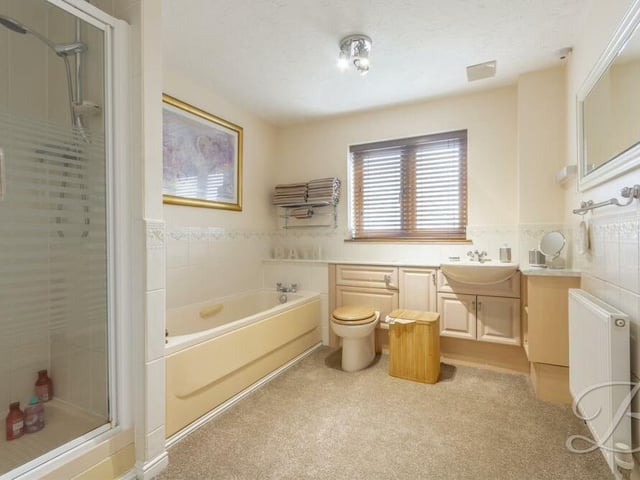 In addition to the en suite to the master bedroom, the first floor houses this family bathroom. It comes complete with a fitted bath, separate walk-in shower cubicle, low-flush WC and vanity hand wash basin.