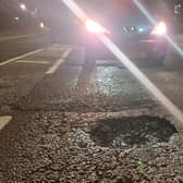 A car approaches a large pothole on Hamilton Road in Sutton.