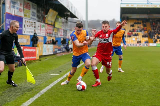 Mansfield Town midfielder Ollie Clarke  battles with Middlesbrough midfielder Caolan Boyd-Munce. Picture by Chris Holloway/The Bigger Picture.media