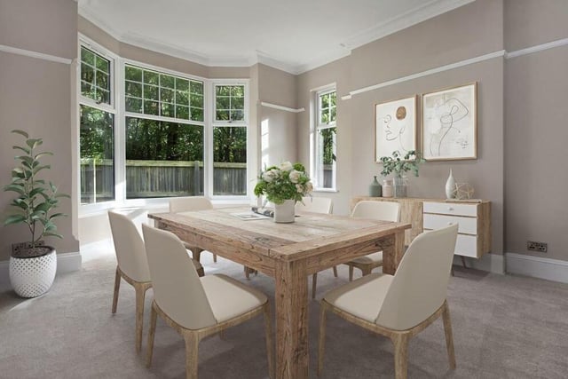 The dining room is a bright and pleasant setting for meals with family or friends. It includes a picture rail, coving to the ceiling and a large bay window facing the side of the £625,000 house.