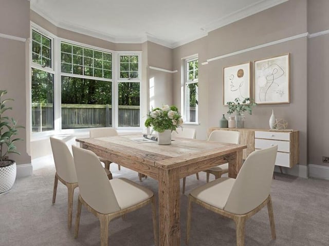 The dining room is a bright and pleasant setting for meals with family or friends. It includes a picture rail, coving to the ceiling and a large bay window facing the side of the £625,000 house.