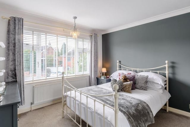 Here is the delightful second bedroom, which also features fitted wardrobes that have hanging rails, shelving and sliding doors. The double-glazed window overlooks the front of the property.