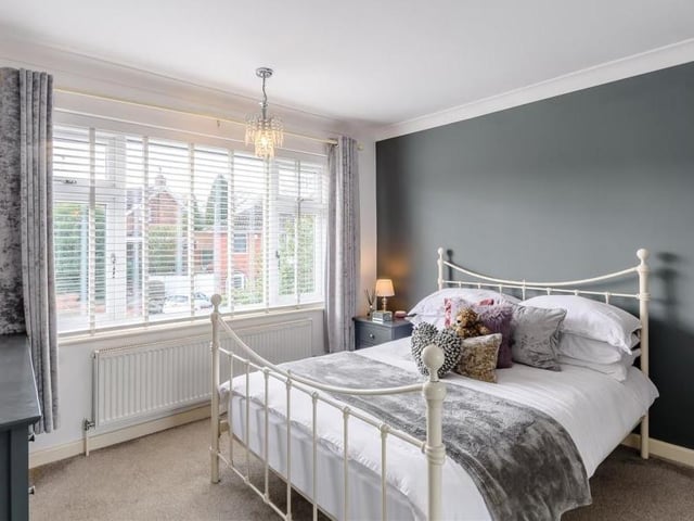 Here is the delightful second bedroom, which also features fitted wardrobes that have hanging rails, shelving and sliding doors. The double-glazed window overlooks the front of the property.