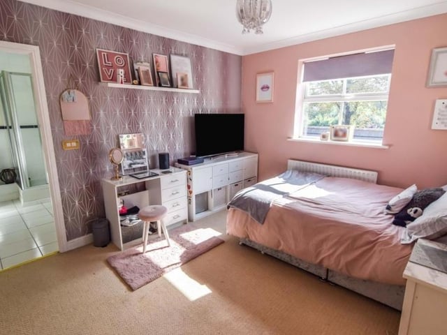 On to the first floor now and here is the first bedroom, which has access to an en suite bathroom (left).