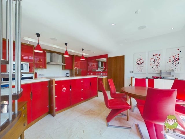 Integrated appliances within the kitchen include a double fridge/freezer, washer/dryer, dishwasher, wine cooler and wine store.