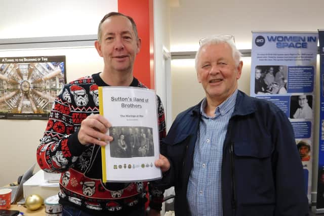 Steve Waring (right) presents his booklet, 'Sutton's Band Of Brothers -- The Warings At War', to Darron Ellis, of the Sutton Living Memory Group.
