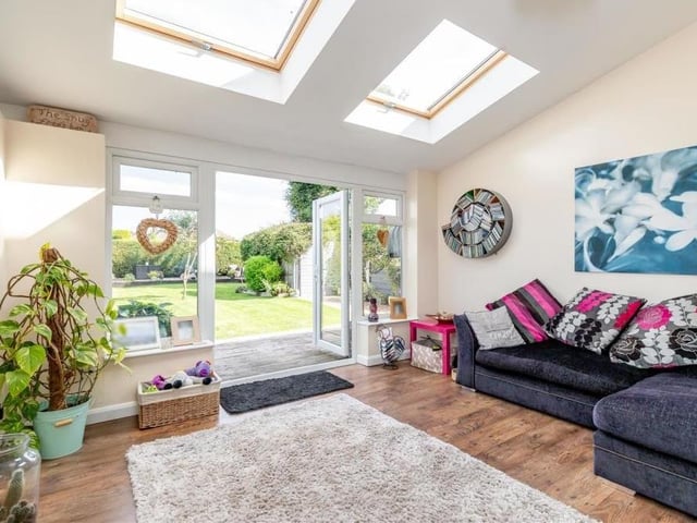 From the open-plan lounge/diner, you move into this delightful garden room, with its laminated floor and Velux roof windows. French doors lead out to the landscaped back garden.