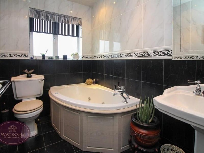 The attractive family bathroom comprises a three-piece suite with WC, corner bath and pedestal sink unit. There are also ceiling spotlights and a traditional radiator/heated towel-rail.