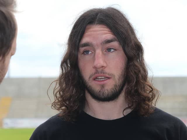 Sporting considerably more hair than now, Northampton Town new signing John-Joe O'Toole looks on during a photo call at Sixfields Stadium on June 30, 2014.