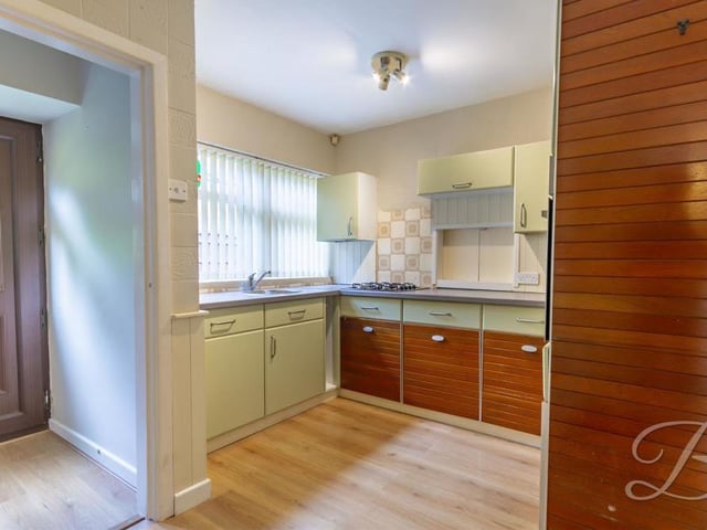 Here is our first glimpse of the kitchen, which sits next door to the lounge, just off a hall with a door leading to the back of the bungalow.