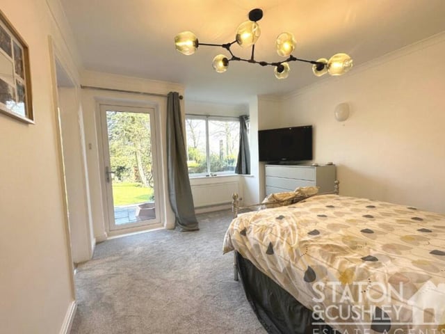 The master bedroom sits on the ground floor of the Chesterfield Road South property. It has a uPVC double-glazed door opening out on to the back garden, plus access to a walk-in dressing room and en suite bathroom.