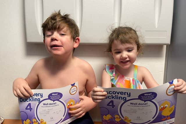 Linus and Dolly with Swimming Certificates.
