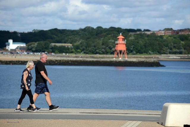 A couple enjoy a walk along the South Pier.