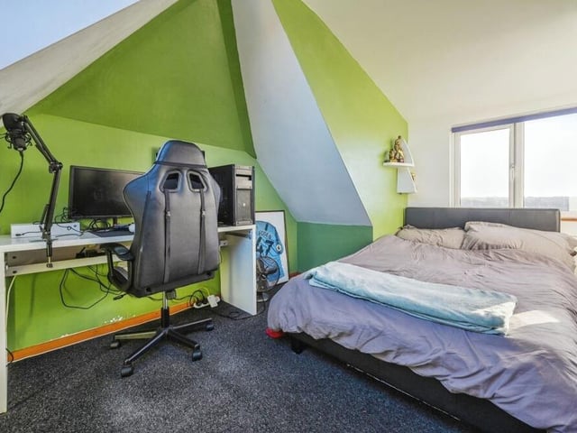 Another set of stairs takes us to the second floor, where the excellent loft conversion can be viewed in all its glory. It contains two bedrooms, including this one, which has windows to the front and back, and space for desk.