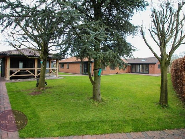 The final photo in our gallery shows the back garden, from where there are open views over fields and beyond. To the left is the annexe and to the centre and right is the main bungalow.