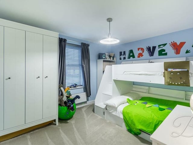 The third bedroom is set up ideally for a child, but there is also plenty of wardrobe space.