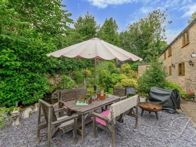Time to step outside now, and a lovely feature of the leafy garden is this patio seating area.