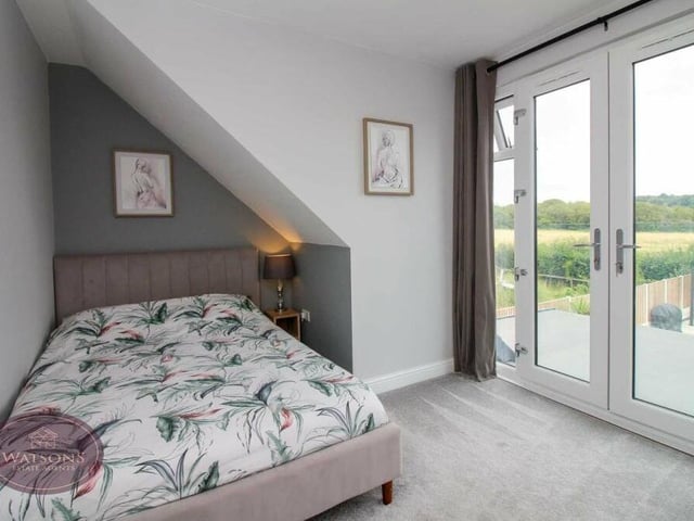 This bedroom on the first floor is also blessed with a glass Juliet balcony, offering open views of the back garden and beyond.